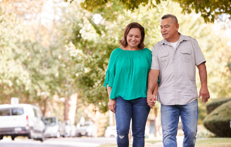Casal passeando por um condomínio | Diferença entre condomínio fechado e bairro aberto | Como comprar uma casa | Blog Alea